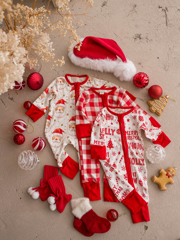 All I Wish Christmas baby onesies laid out together including the Dear Santa print - Before & Ever Kids