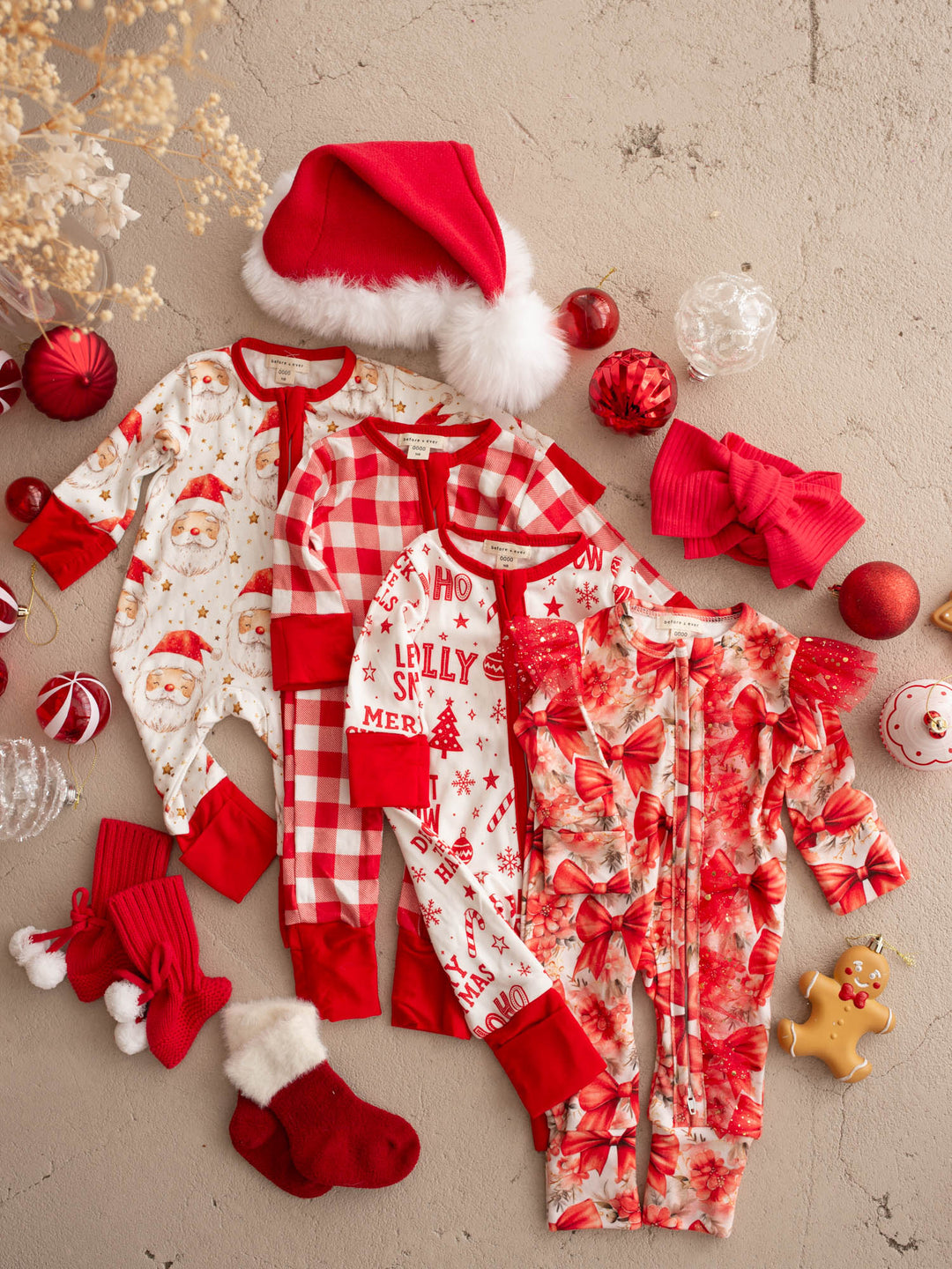 All I Wish Christmas baby onesies laid out together including the Jolly print - Before & Ever Kids