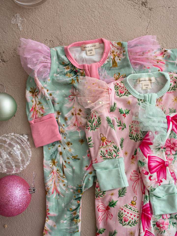 All I Wish Christmas baby onesies and topknots laid out together including the Mint Pine print - Before & Ever Kids
