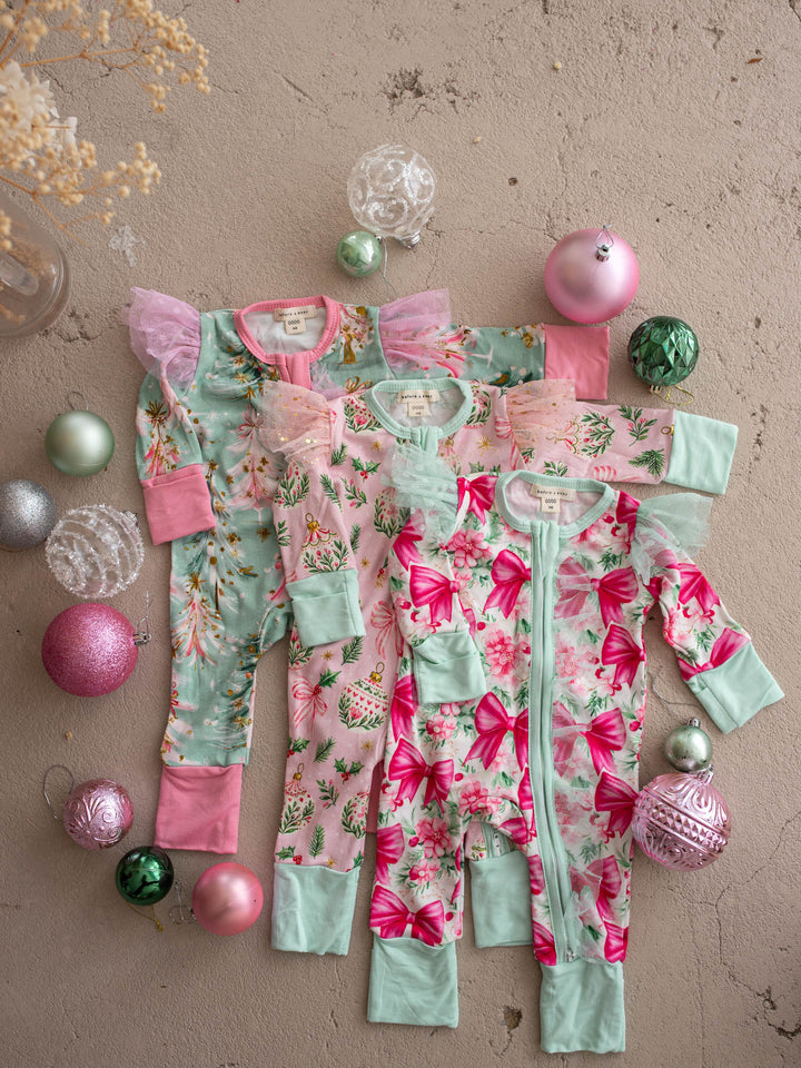 All I Wish Christmas baby onesies and topknots laid out together including the Mint Pine print - Before & Ever Kids