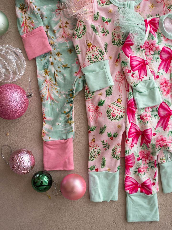 All I Wish Christmas baby onesies and topknots laid out together including the Pink Bow print - Before & Ever Kids