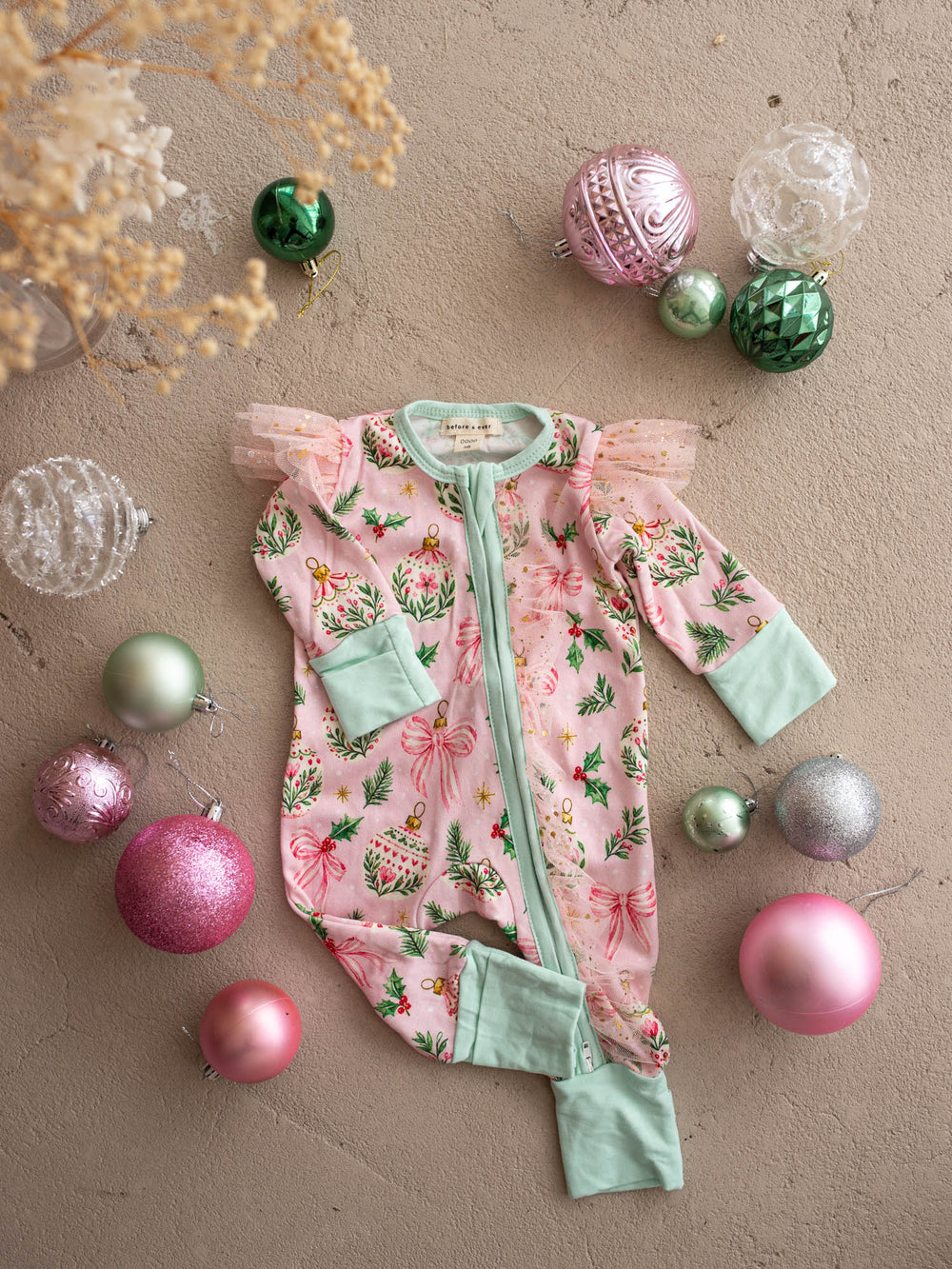 All I Wish Pink Holly baby onesie, holly, gold baubles and bows on pink with mint cuffs - Before & Ever Kids