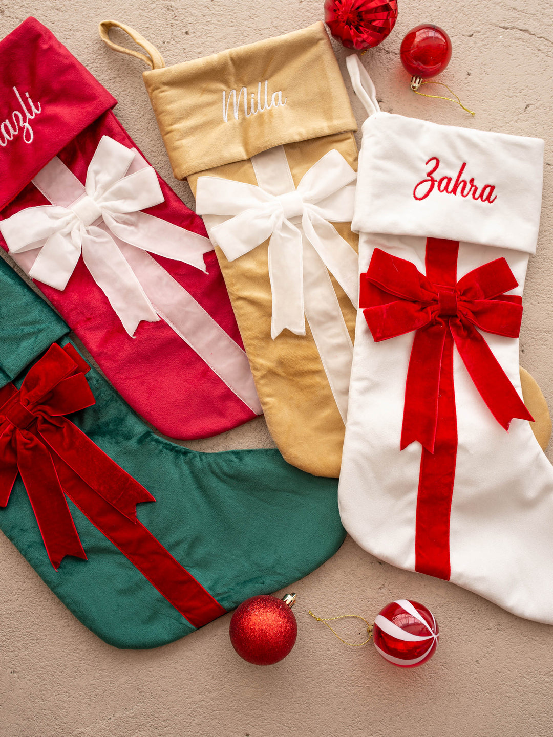 All Wrapped Up personalised Christmas stocking, all four colours laid together with Christmas baubles - Before & Ever Kids