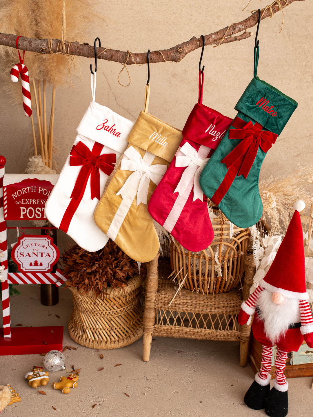 All Wrapped Up personalised Christmas stocking, four stockings hanging side by side above Christmas decorations - Before & Ever Kids