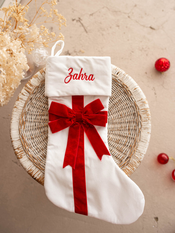 All Wrapped Up personalised Christmas stocking, white velvet with a red ribbon and bow, name embroidered on the cuff - Before & Ever Kids
