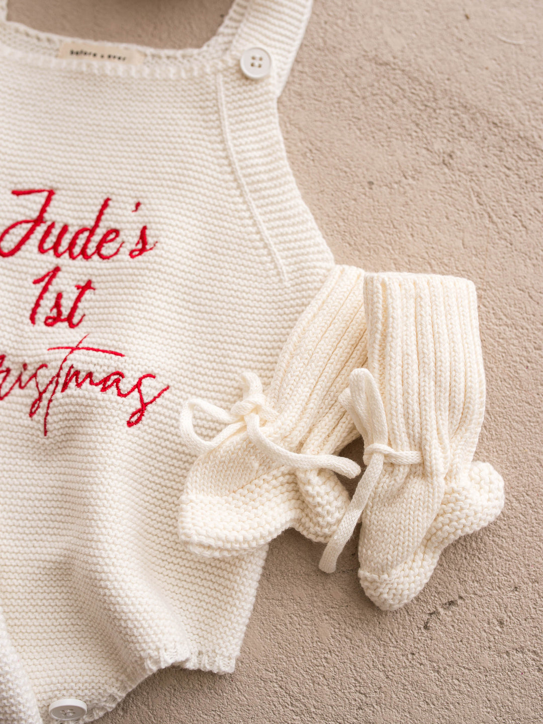 Bliss Knitted Booties in milk cotton knit with ankle ties, beside a personalised knit romper - Before & Ever Kids