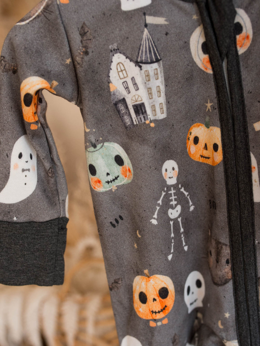 Close up of Boo Crew Halloween print with ghosts, haunted house and jack-o-lanterns on charcoal bamboo onesie - Before & Ever Kids