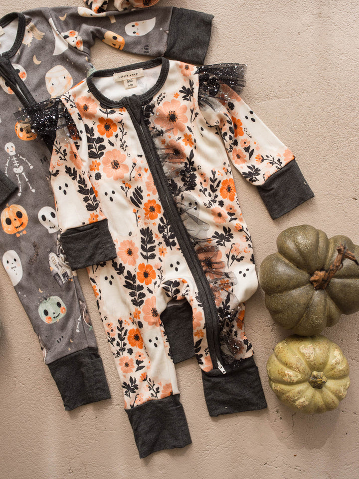 Boo-quet ivory floral Halloween onesie flat lay beside Boo Crew charcoal onesie - Before & Ever Kids