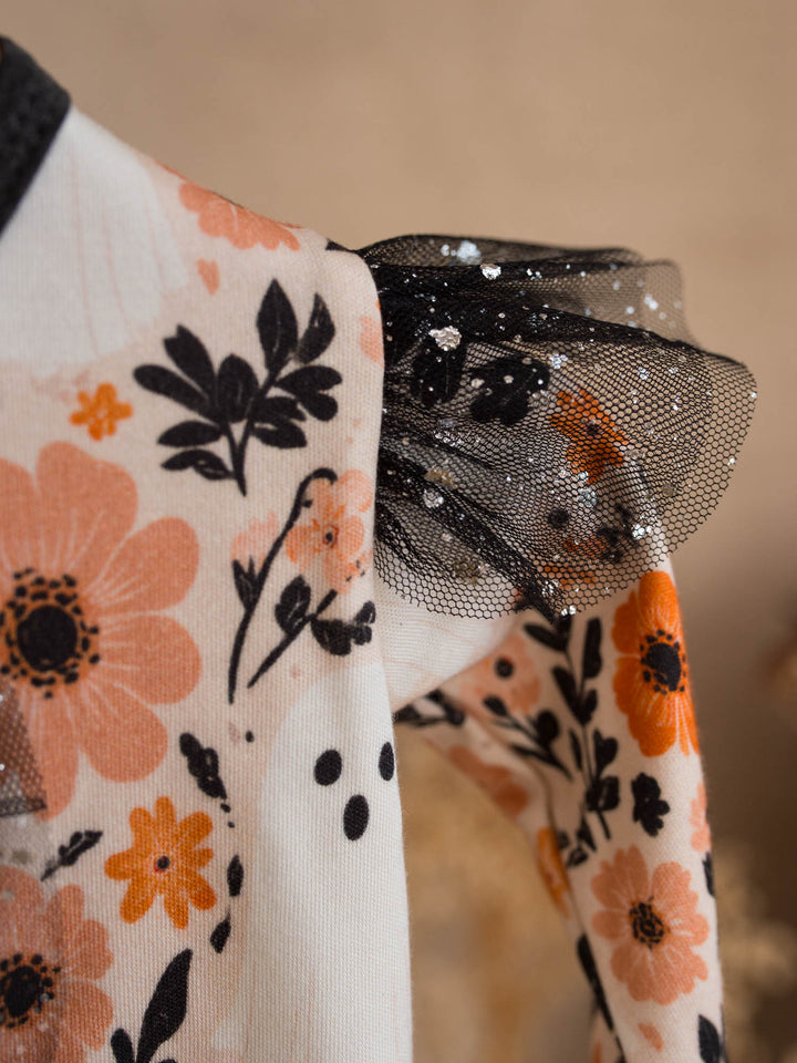 Boo-quet onesie detail showing black glitter tulle shoulder ruffle and floral print - Before & Ever Kids
