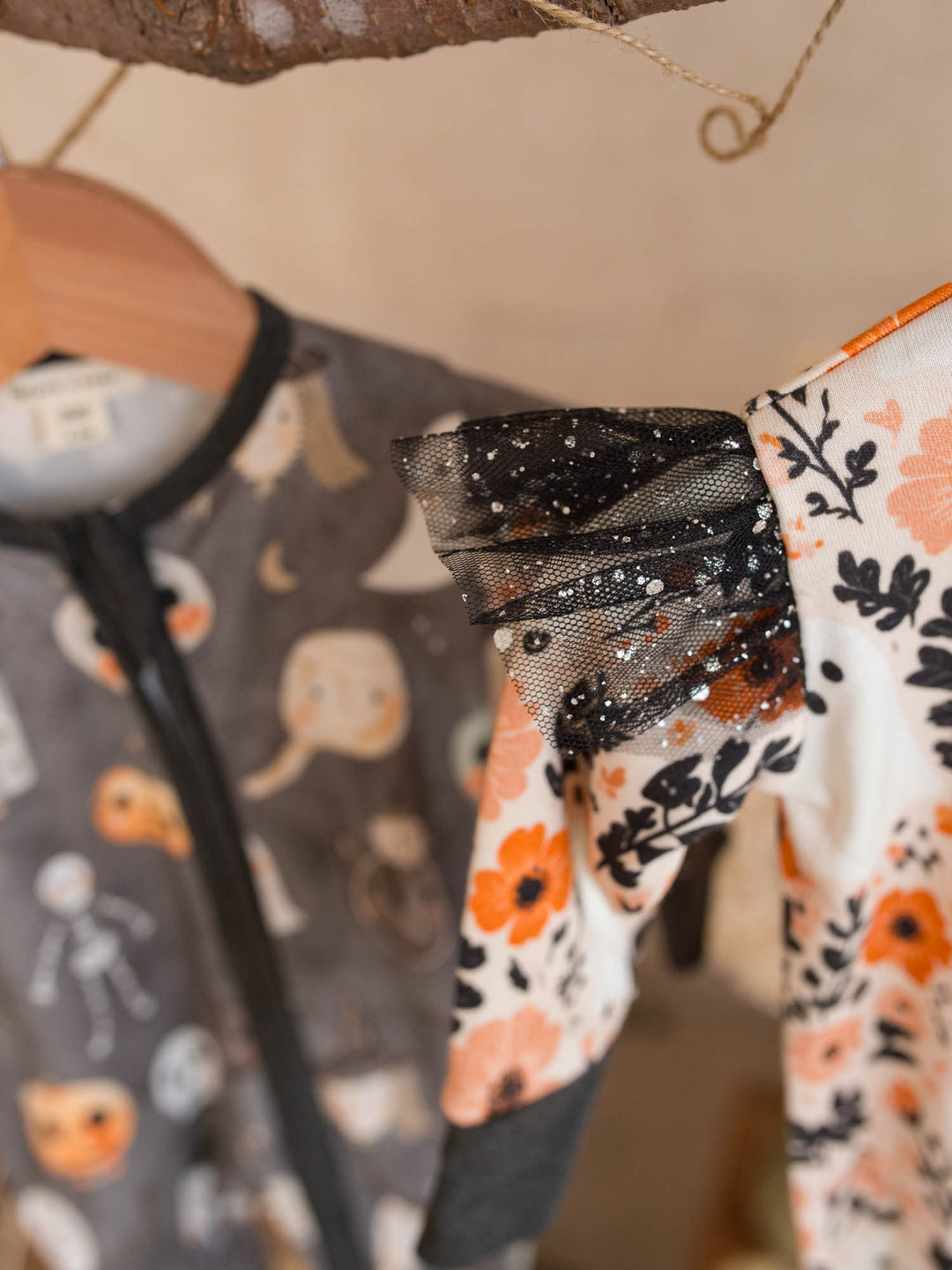 Boo-quet floral onesie with black glitter tulle sleeve beside Boo Crew charcoal onesie - Before & Ever Kids