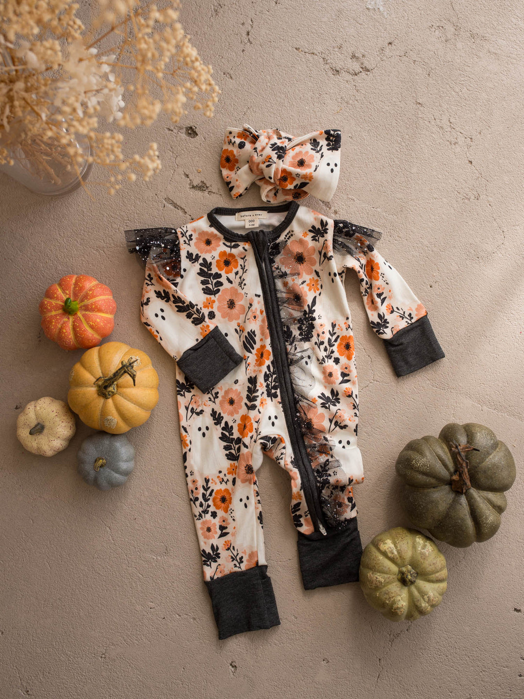 Boo-quet topknot headwrap flat lay with the matching floral baby onesie - Before & Ever Kids