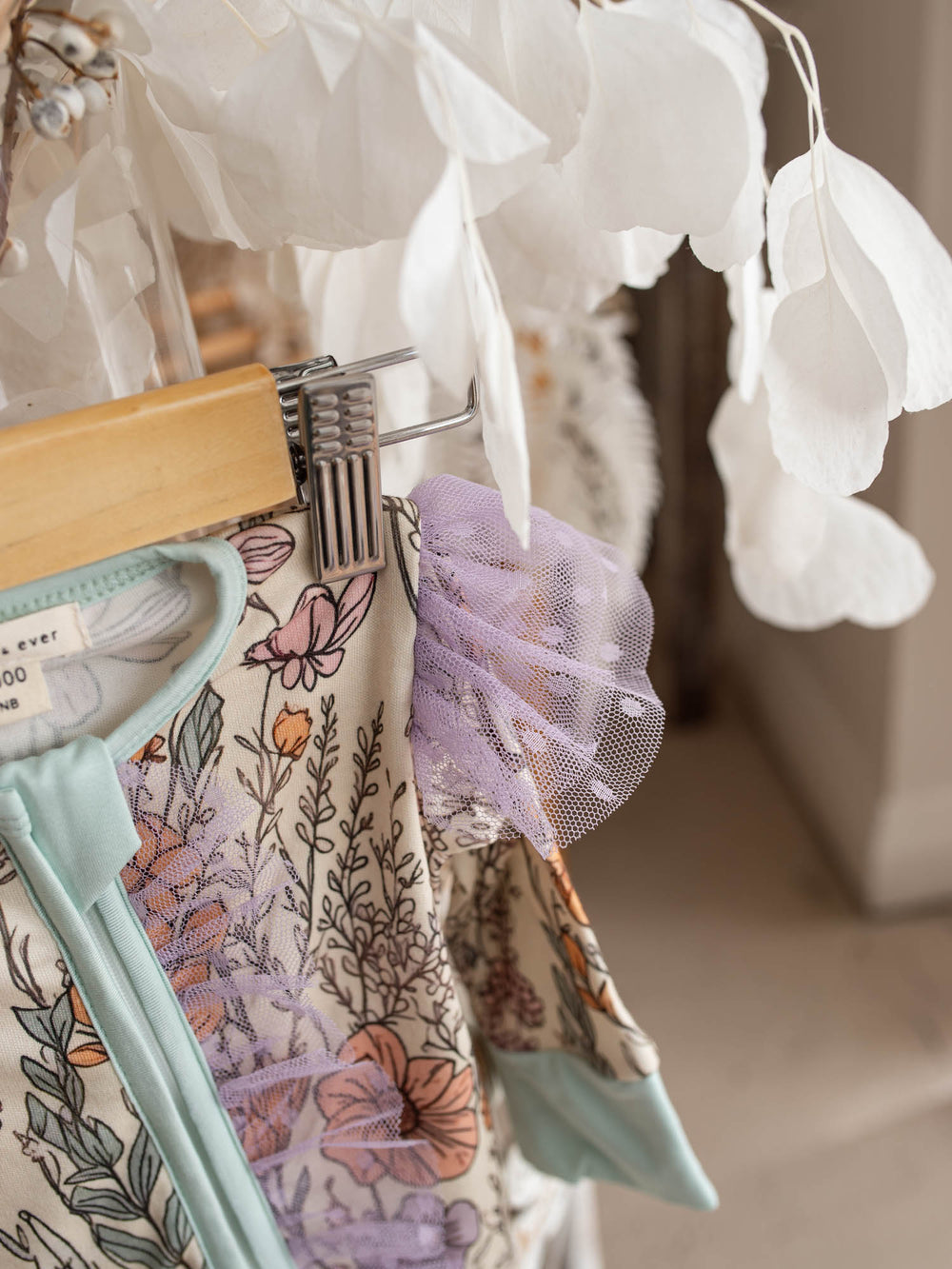 Dainty Miss lavender floral bamboo viscose baby girl onesie with a two-way zipper, convertible mittens, footies and long sleeves.