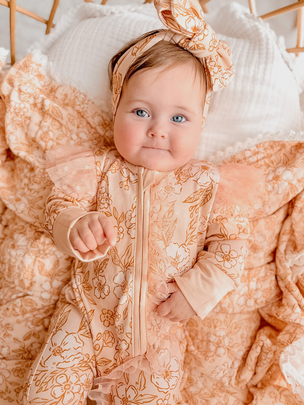Dainty Miss peach blossom floral bamboo viscose baby girl onesie with a two-way zipper, convertible mittens, footies and long sleeves.