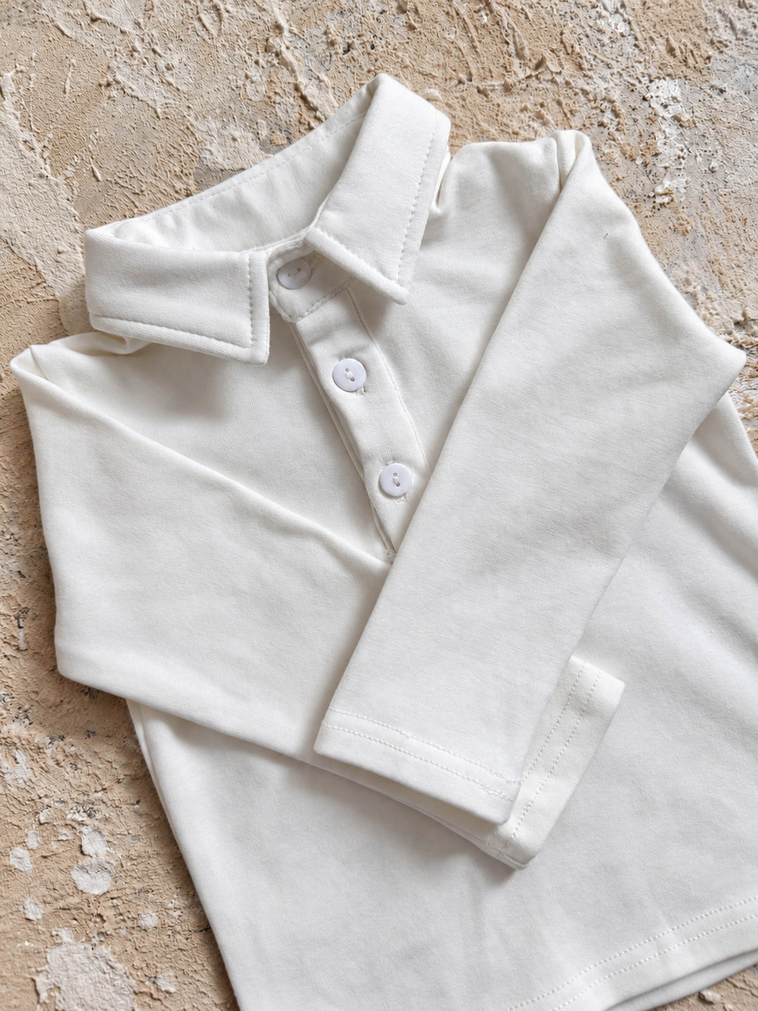 Everyday Cotton Polo, white long sleeve cotton polo, folded, showing the collar and long sleeve - Before & Ever Kids