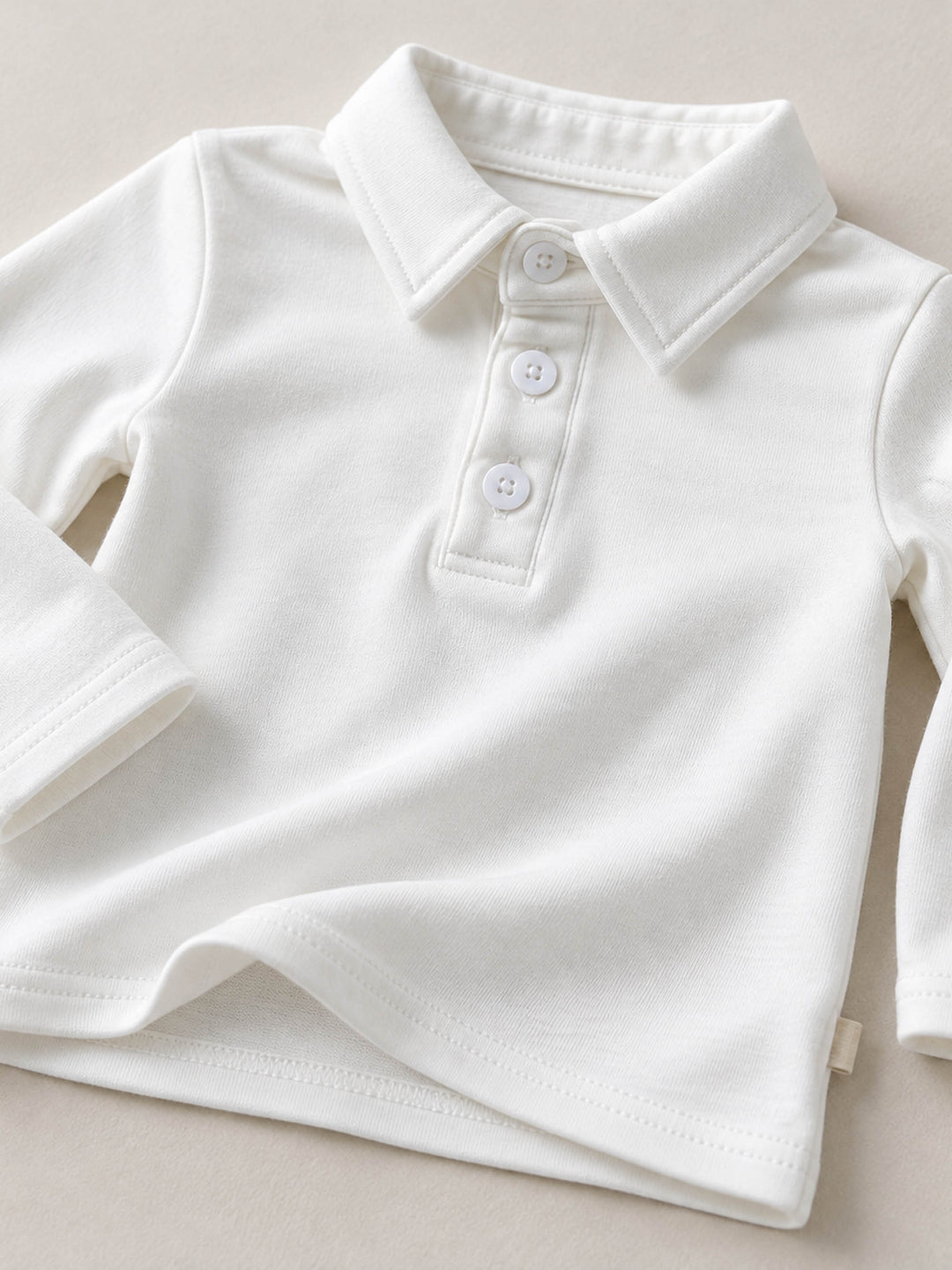 Everyday Cotton Polo, white long sleeve cotton polo, close up of the collar and button placket - Before & Ever Kids