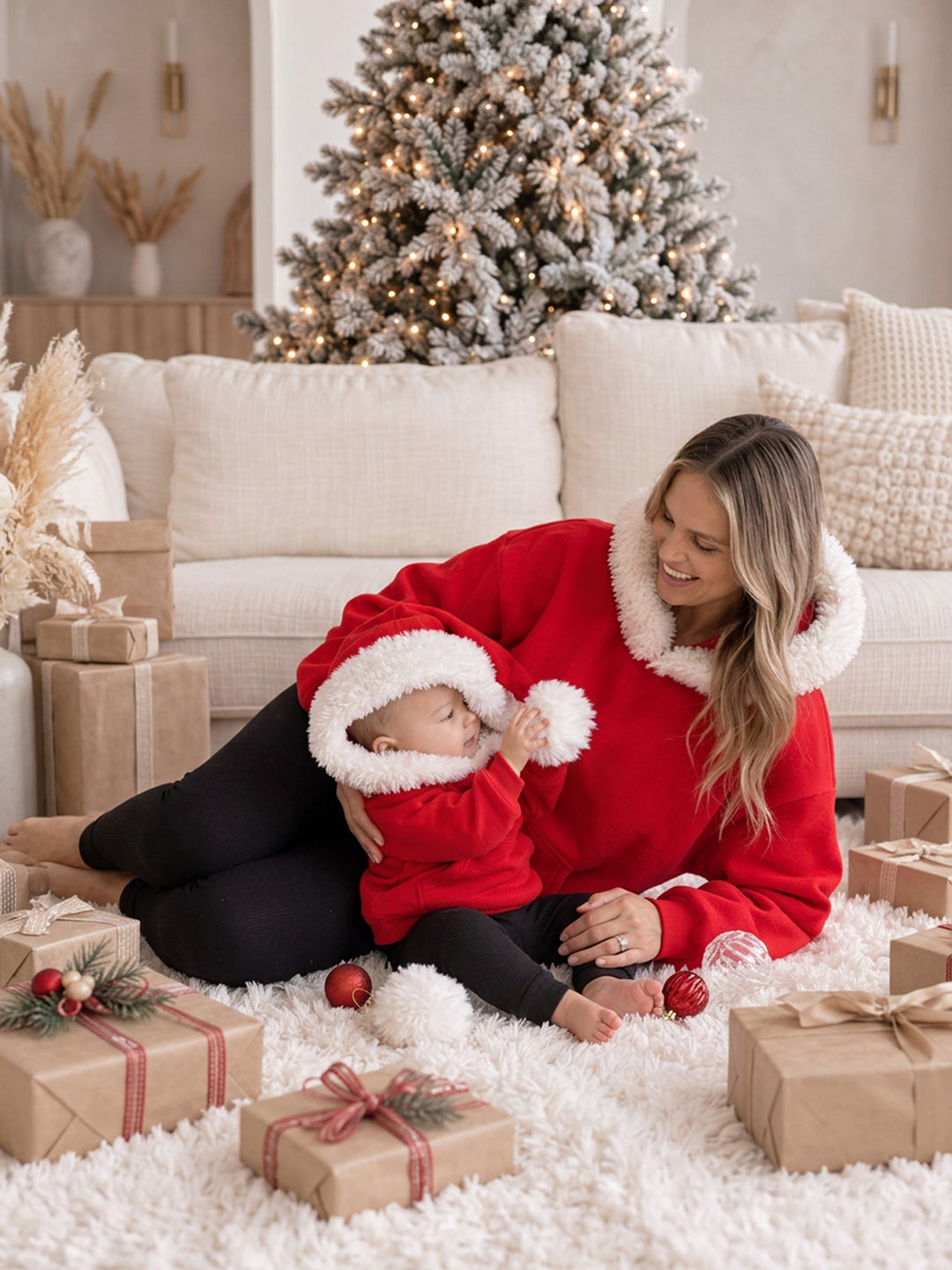 Ho Ho Hoodie red kids hoodie with the hood up, a baby holding the white pom-pom - Before & Ever Kids