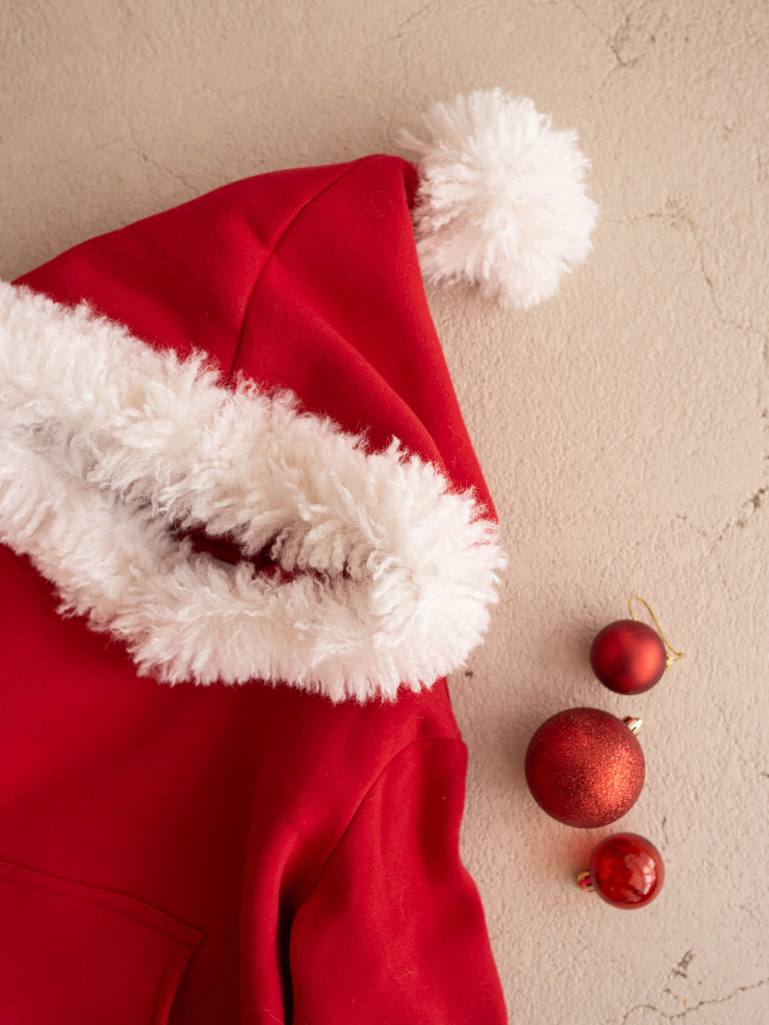 Close up of the white fluffy hood trim and pom-pom on the Ho Ho Hoodie - Before & Ever Kids