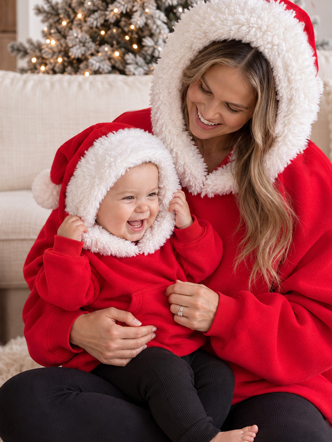 Ho Ho Hoodie red adult hoodie close up, Santa hat hood up on a mum holding a laughing baby in the matching hoodie - Before & Ever Kids