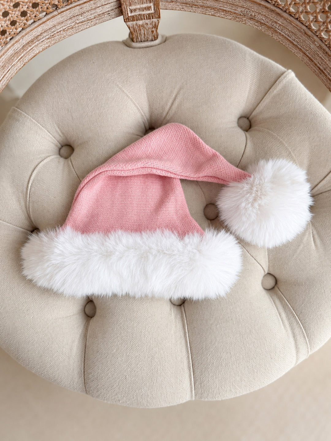 Baby pink knitted Santa hat with white fluffy trim and pom-pom
