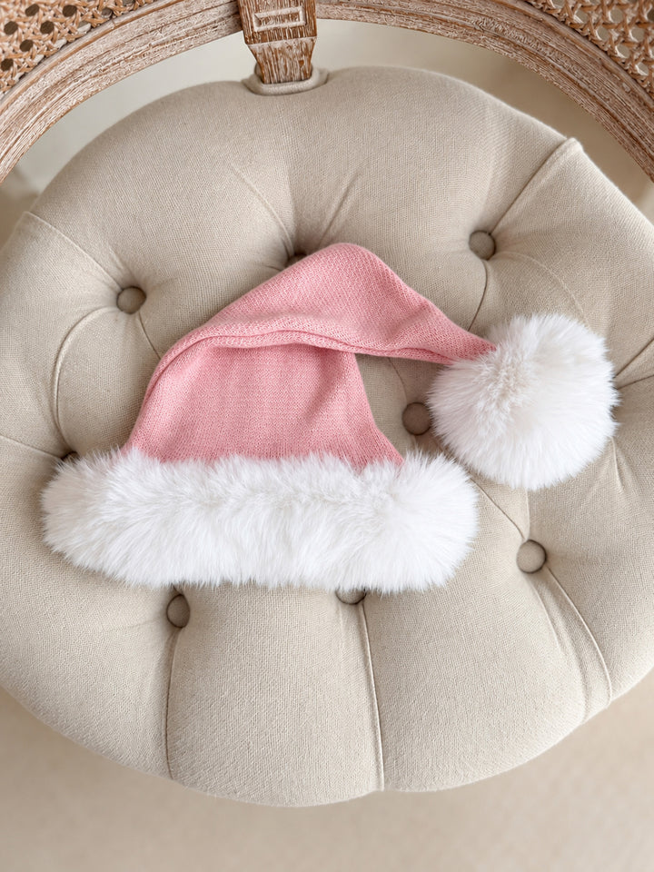 Baby pink knitted Santa hat with white fluffy trim and pom-pom