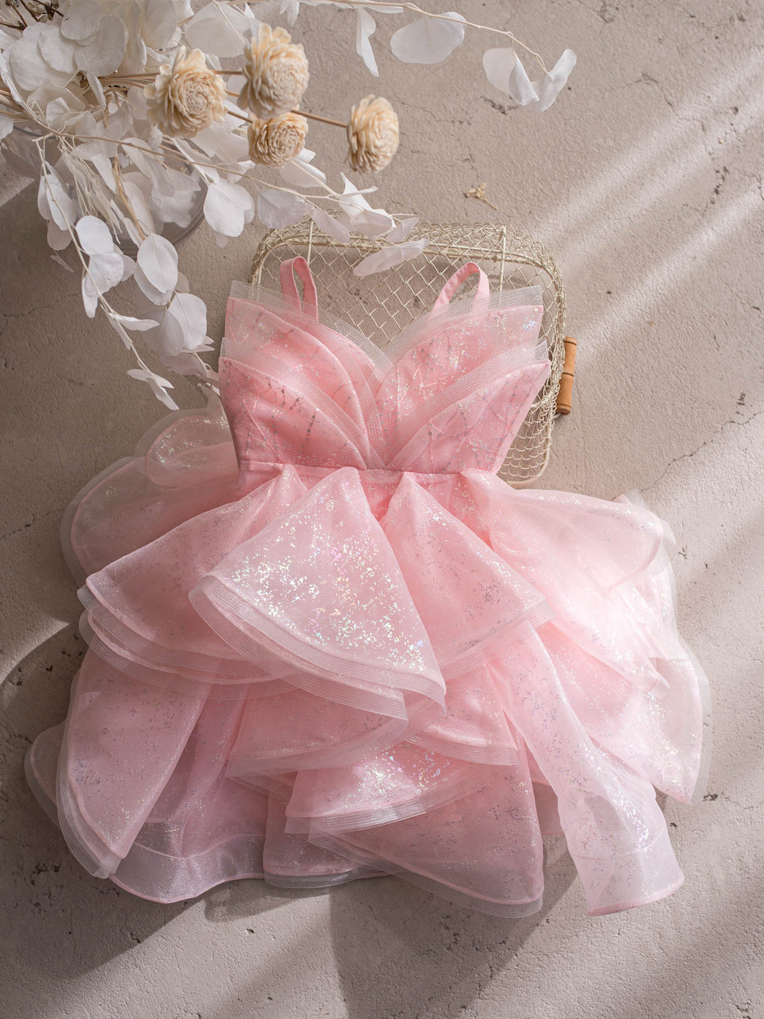 Little Good Witch pink glitter organza dress full dress styled on a chair - Before & Ever Kids