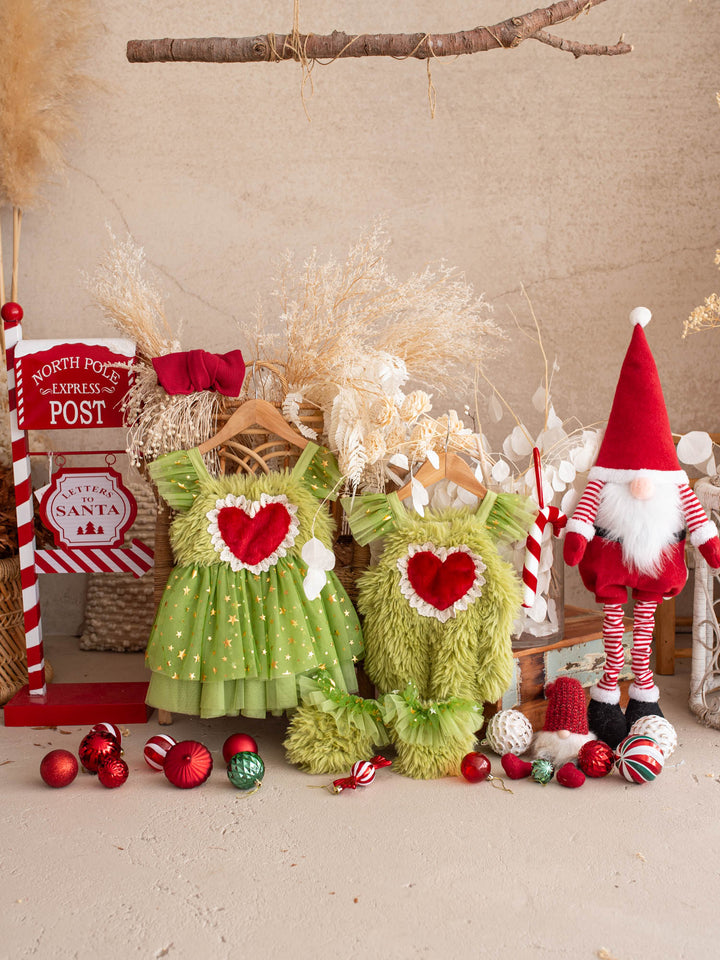 Matching Miss Grump Christmas dress and Little Grump romper hanging together with a Santa gnome, a candy cane and red baubles - Before & Ever Kids
