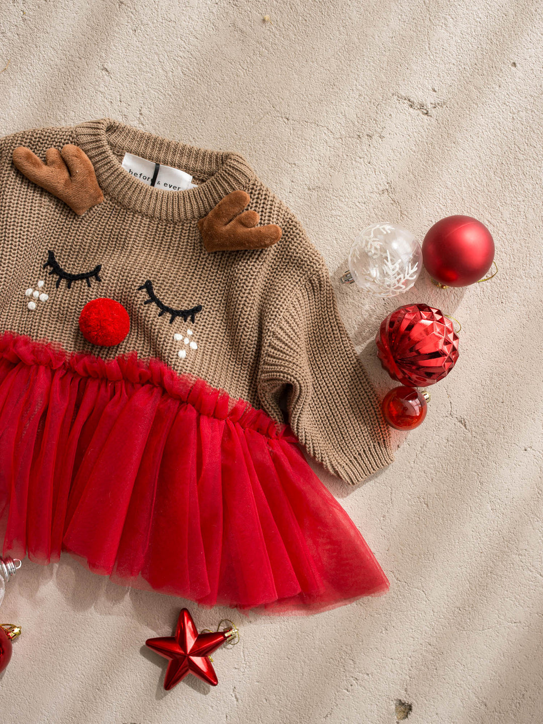 Little Reindeer Sweater brown and red camel knit sweater with an embroidered sleeping reindeer face, felt antlers and a red tulle frill across the front - Before & Ever Kids
