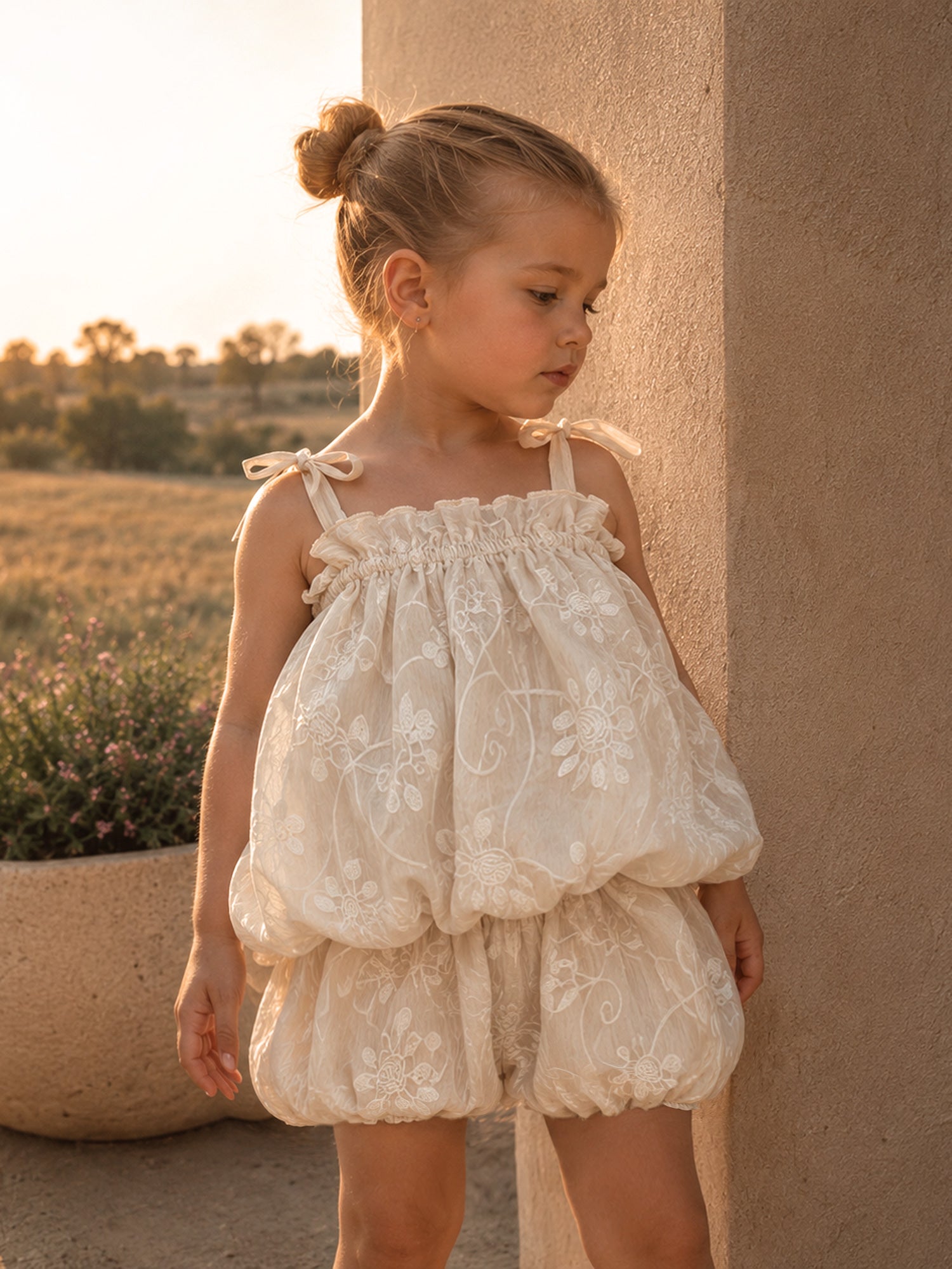 Love, Always ivory baby girl set with tonal floral embroidery, bow-tie straps, a ruffle neckline, bubble hem top and matching bloomer shorts.