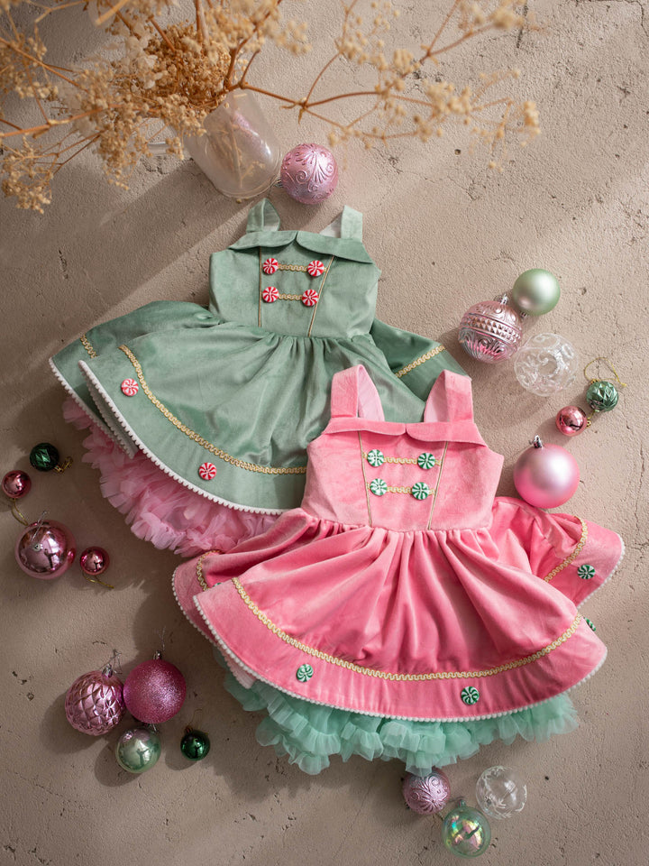 Merry Berry pink and mint flat lay with the sage green Merry Mint dress, pink velvet pinafore with mint peppermint buttons and gold braid over a mint tulle tutu - Before & Ever Kids