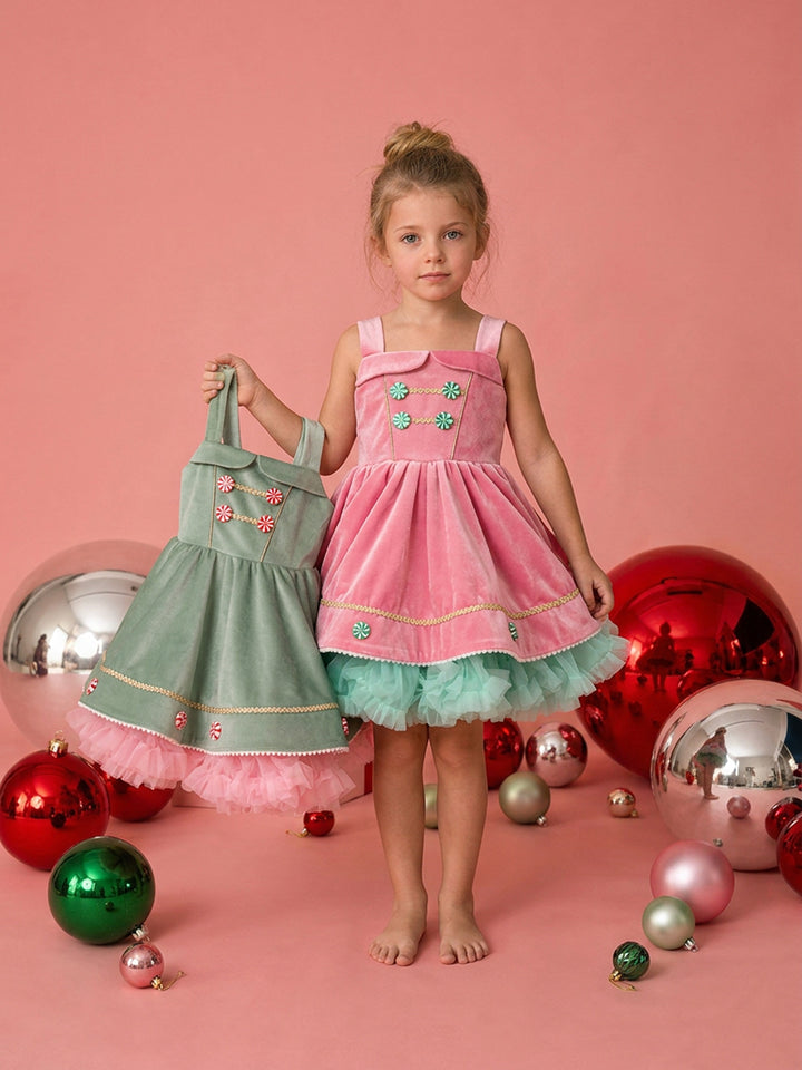 Merry Berry pink and mint worn on model, pink velvet pinafore with mint peppermint buttons over a mint tulle tutu, shown beside the sage green Merry Mint dress - Before & Ever Kids