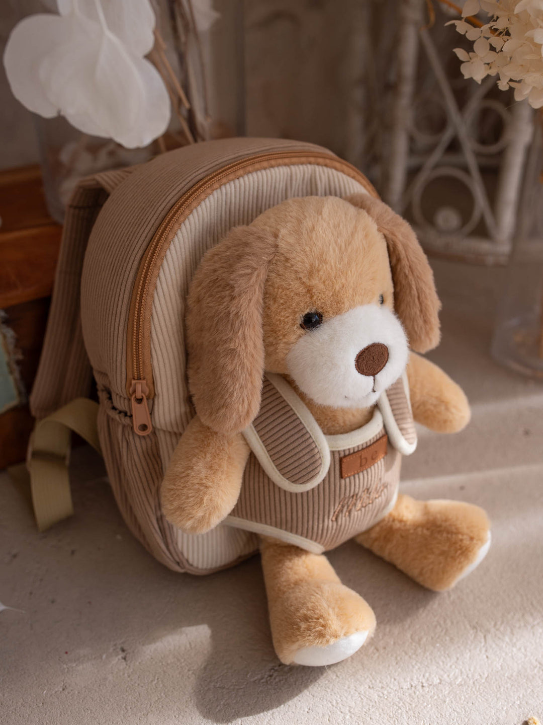 Milo the Puppy personalised Little BFF Companion Backpack, angled view showing the corduroy body and the plush
