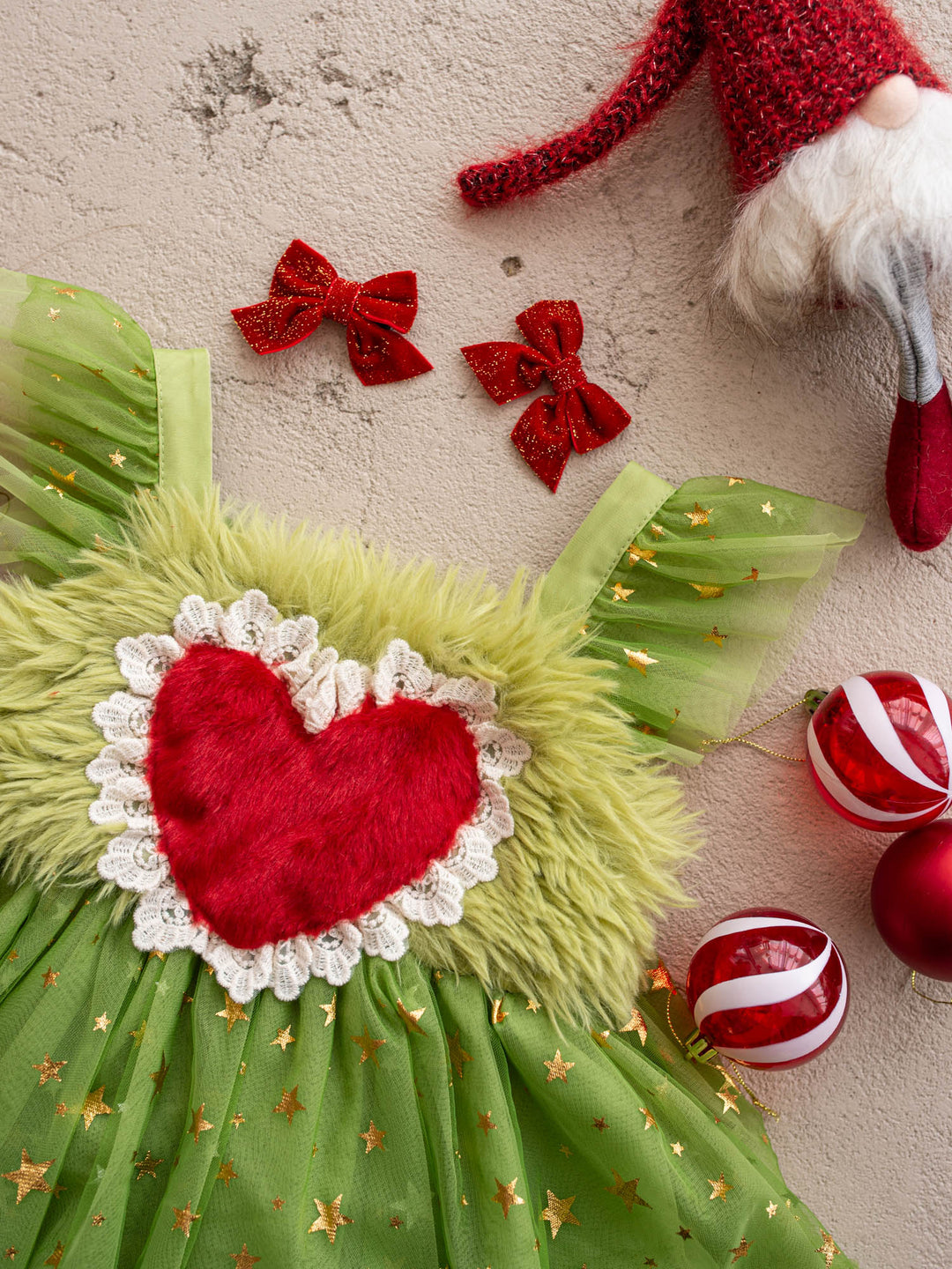 Close-up of the red fur heart and lace trim on the Miss Grump green faux-fur Christmas dress - Before & Ever Kids