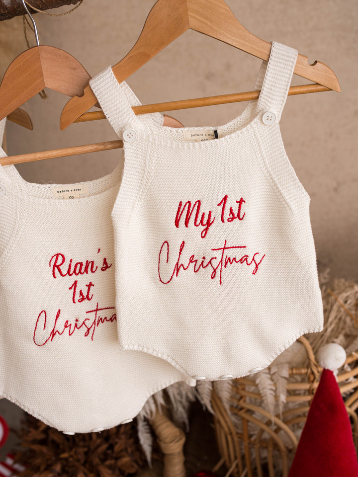 My 1st Christmas Singlet Romper in milk cotton knit with red embroidery, two rompers hanging from a branch - Before & Ever Kids