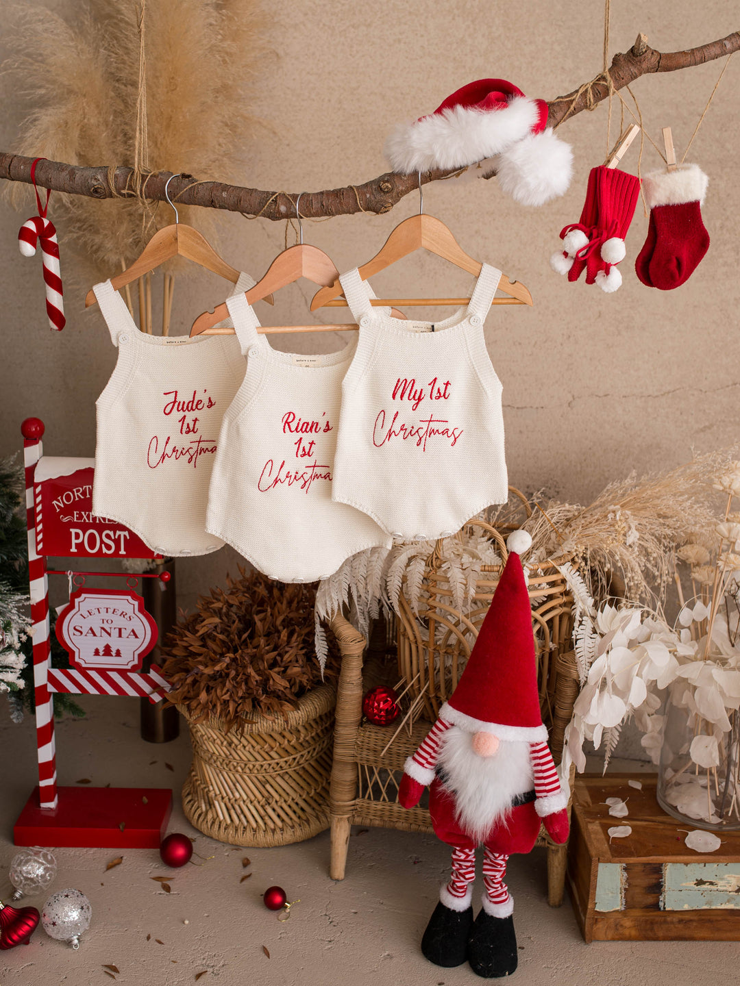 My 1st Christmas Singlet Romper in milk cotton knit with red embroidery, three rompers hanging from a branch with Christmas stockings - Before & Ever Kids