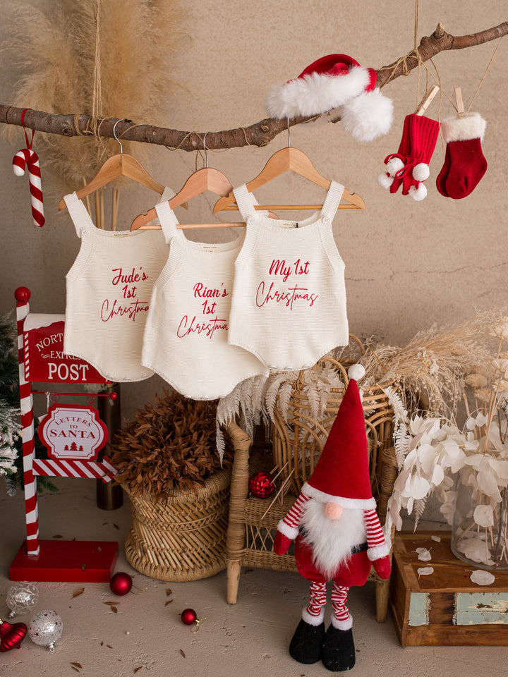 My 1st Christmas Singlet Romper in milk cotton knit with red embroidery, three rompers hanging from a branch with Christmas stockings - Before & Ever Kids