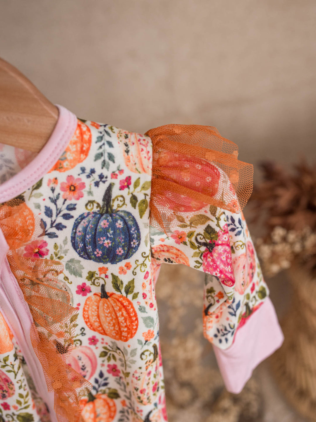 Close up of Patch Perfect pink and coral pumpkin floral print with rust tulle - Before & Ever Kids