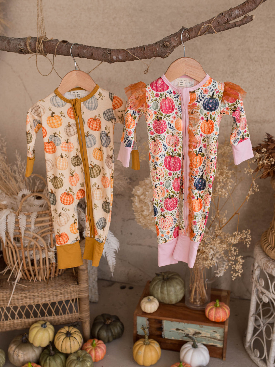 Patch Perfect and Patch Ready matching pumpkin baby onesies hanging together - Before & Ever Kids