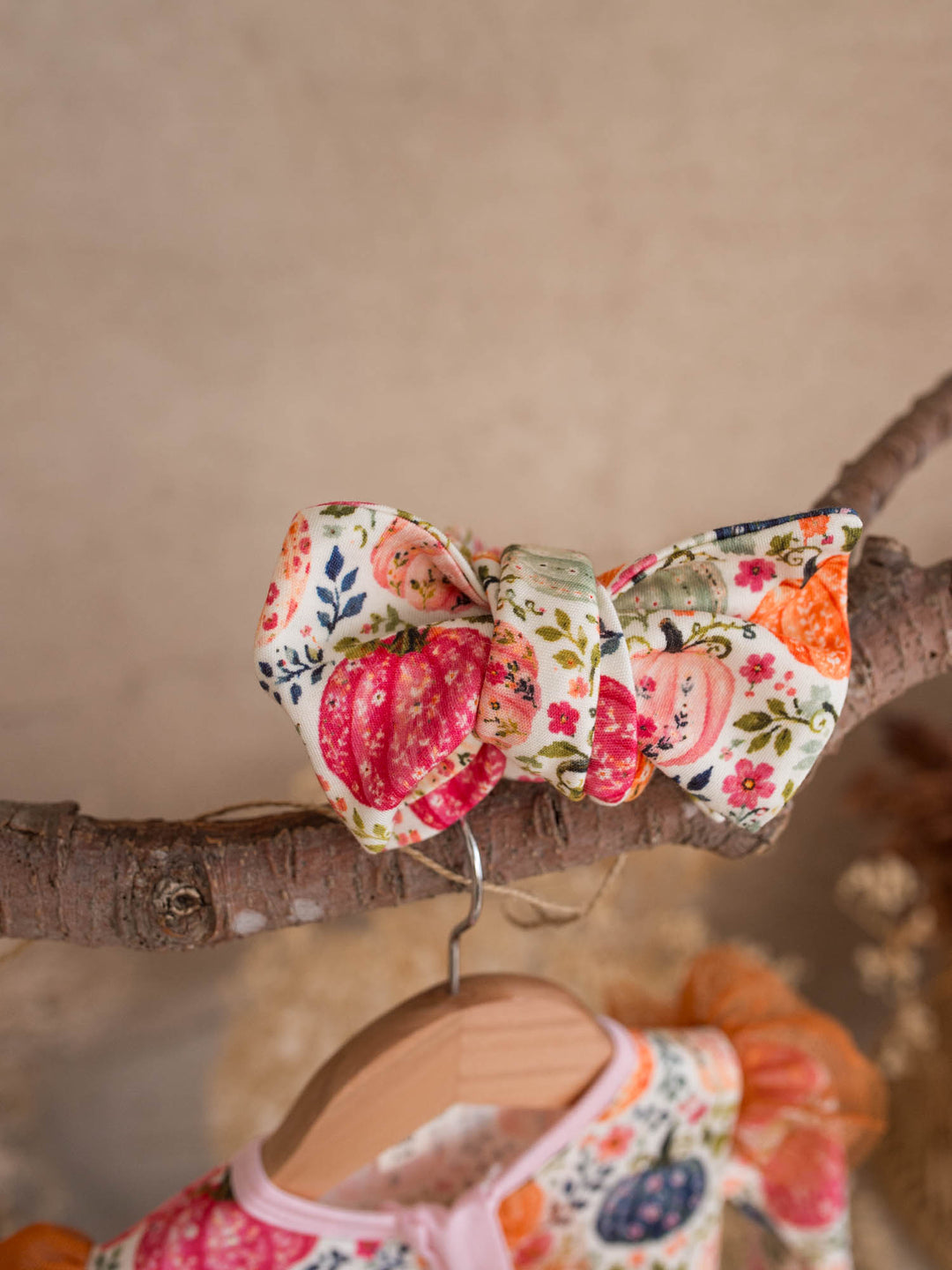Patch Perfect pumpkin floral topknot headwrap above its matching baby onesie - Before & Ever Kids