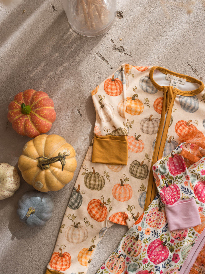 Patch Ready gingham pumpkin onesie flat lay beside Patch Perfect floral pumpkin onesie - Before & Ever Kids