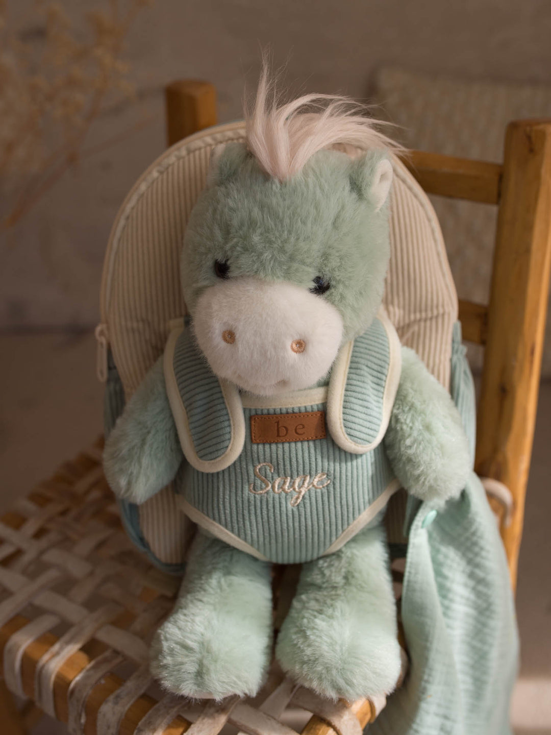 Sage the Horse personalised plush backpack for kids, horse sitting in the backpack on a chair - Before & Ever Kids