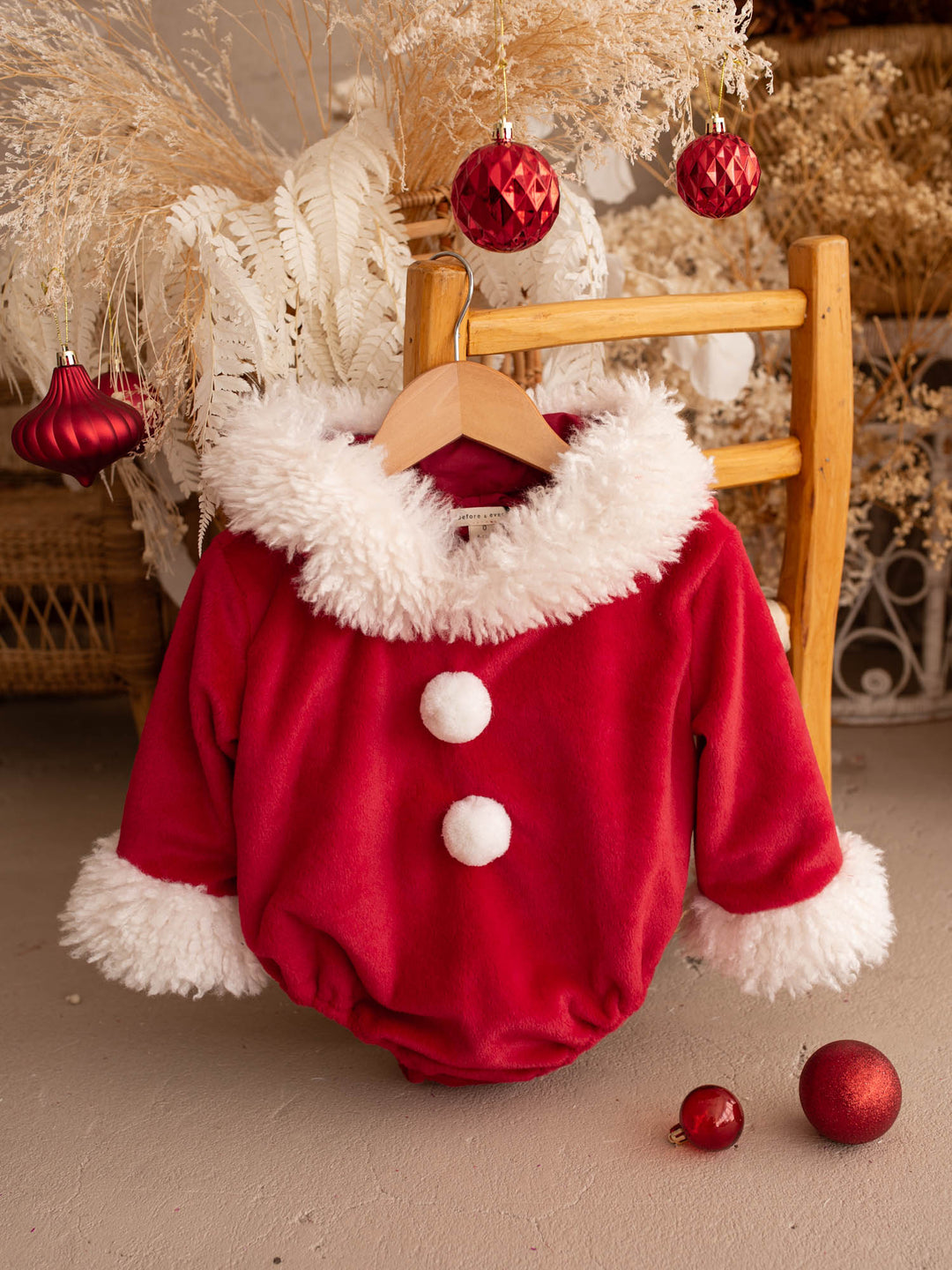 Santa Baby Romper red velvet hooded romper for babies, front view, white fluffy trim and two white pom-poms - Before & Ever Kids