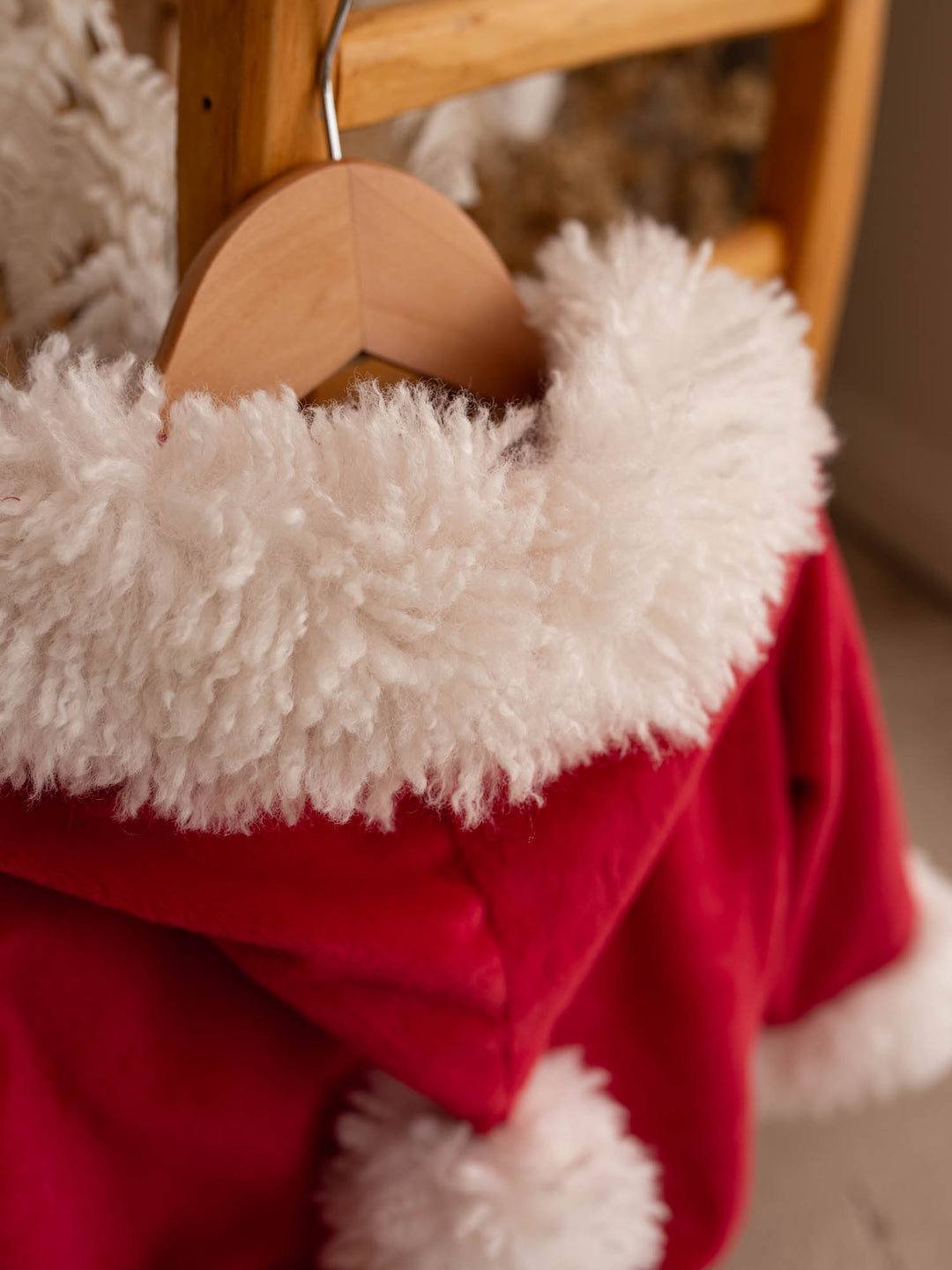 Close up of the hood and fluffy trim on the Santa Baby Romper - Before & Ever Kids