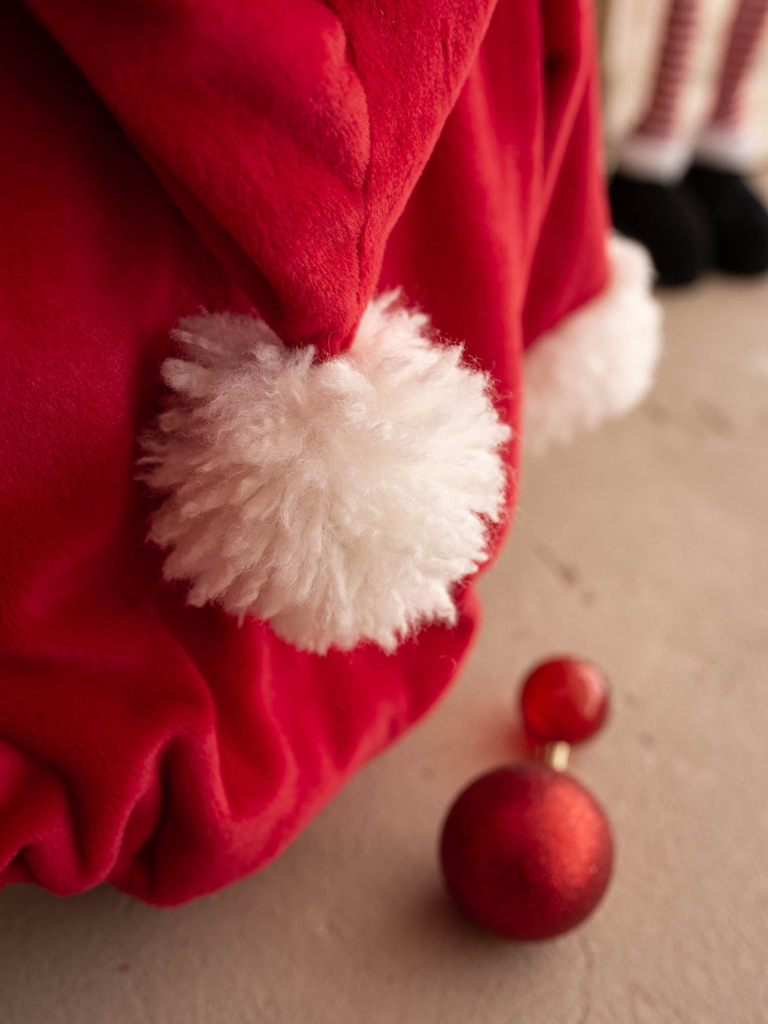 Close up of the white pom-pom on the Santa Baby Romper hood - Before & Ever Kids