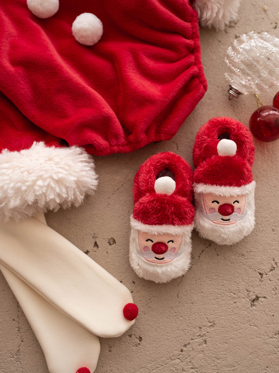 Santa Baby Slippers close up with the Santa Baby Romper pom-poms - Before & Ever Kids