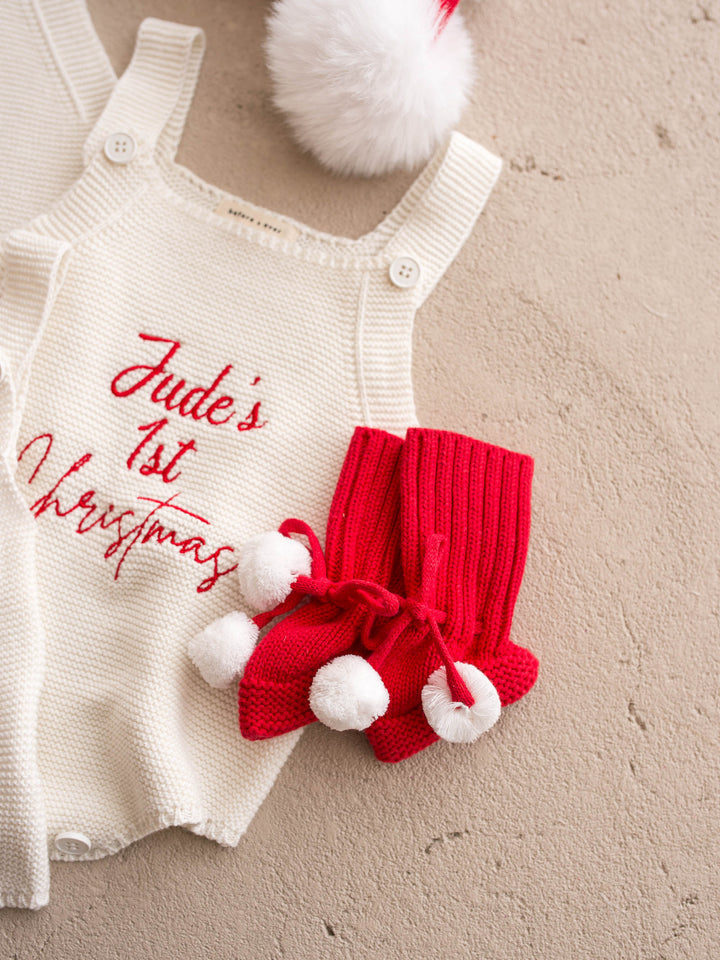 Say My Name Christmas Singlet Romper in milk cotton knit with a personalised name in red, flat with red pom pom booties and baubles - Before & Ever Kids