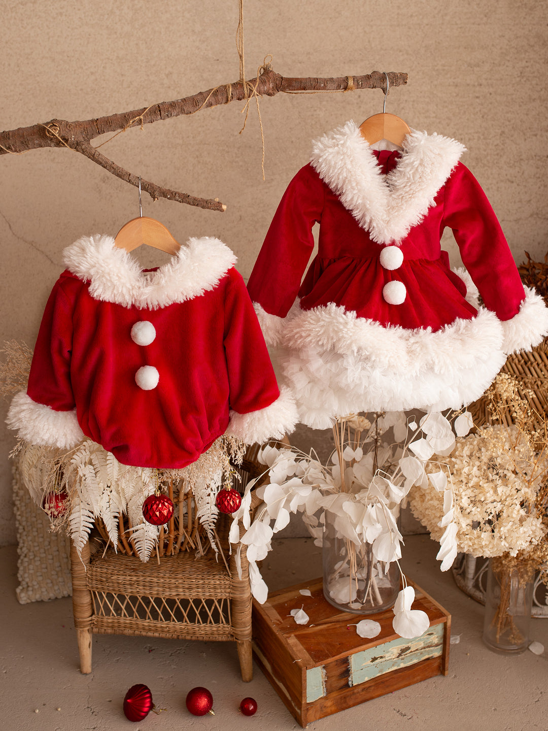 She Came to Sleigh dress and the matching Santa Baby Romper hanging together on a branch - Before & Ever Kids