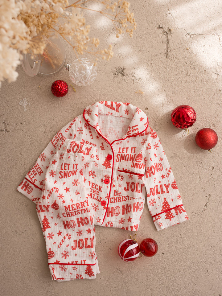 Twas the Night family Christmas pyjamas, white cotton muslin with a red Christmas print, kids long sleeve sleep shirt and sleep pants laid flat together, full front - Before & Ever Kids