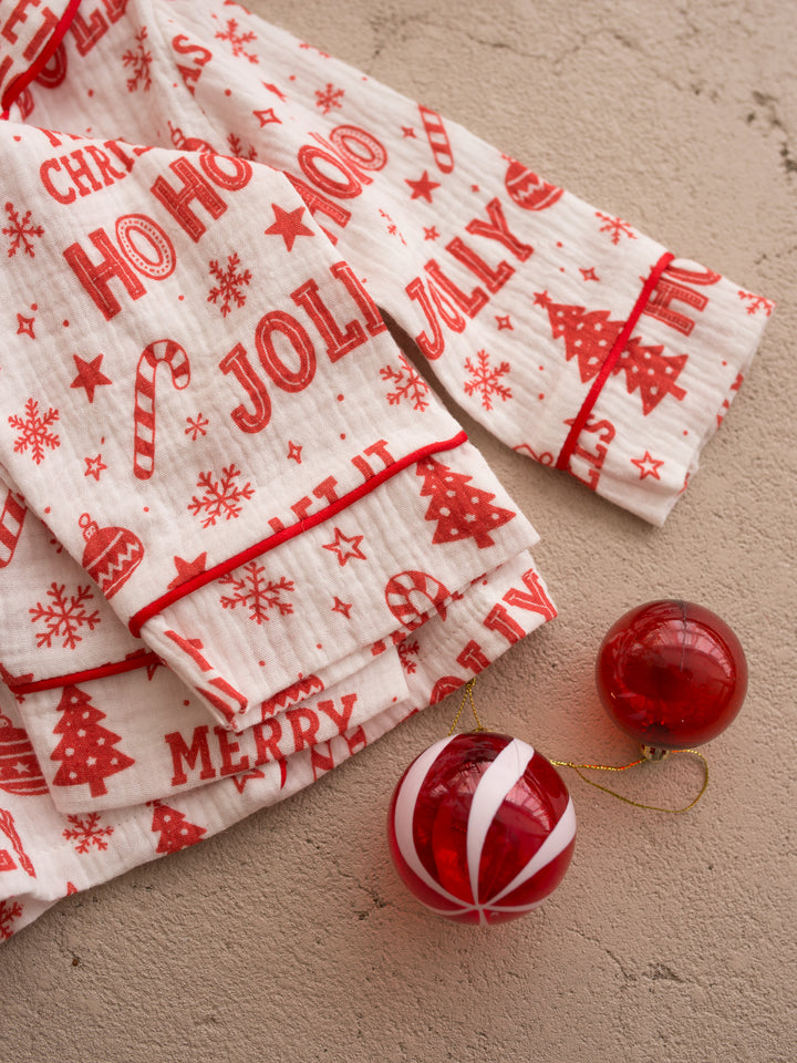 Twas the Night family Christmas pyjamas, white cotton muslin with a red Christmas print, close up of the crinkled muslin texture and red piping - Before & Ever Kids