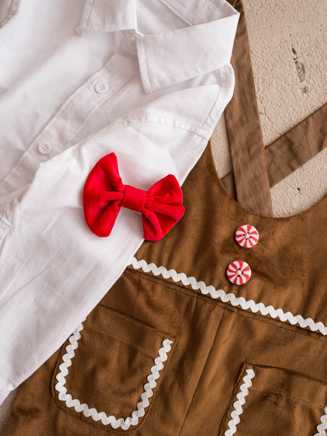 Velvet Bow Tie in red, boys clip on velvet bow tie, on the white shirt beside a caramel velvet overall - Before & Ever Kids