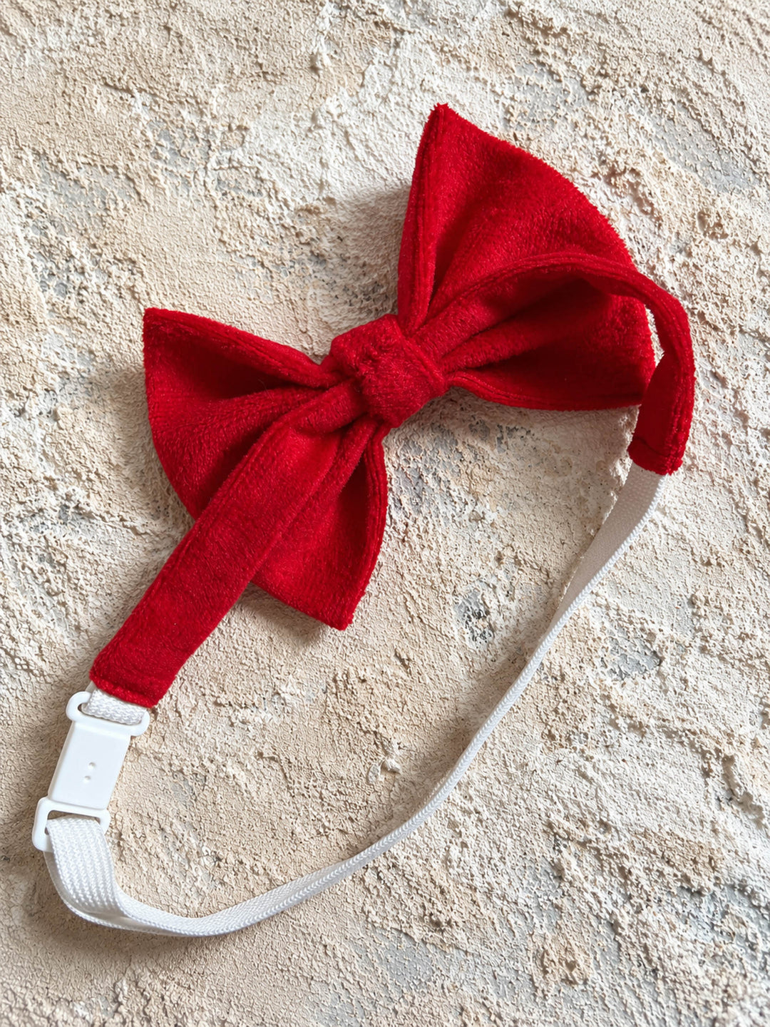Velvet Bow Tie in red, the strap folded behind the bow showing the clip fastening - Before & Ever Kids